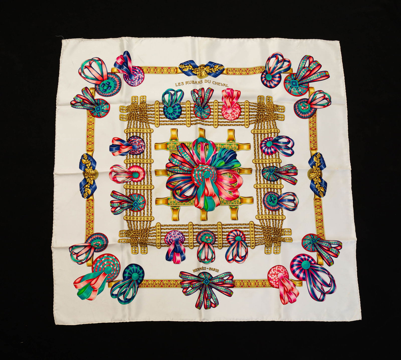 HERMES SILK 90 SCARF "LES RUBANS DU CHEVAL".: Silk. Ivory ground with colorful horse ribbons decorating braided belts. 35" square. In original box. Light wear.
