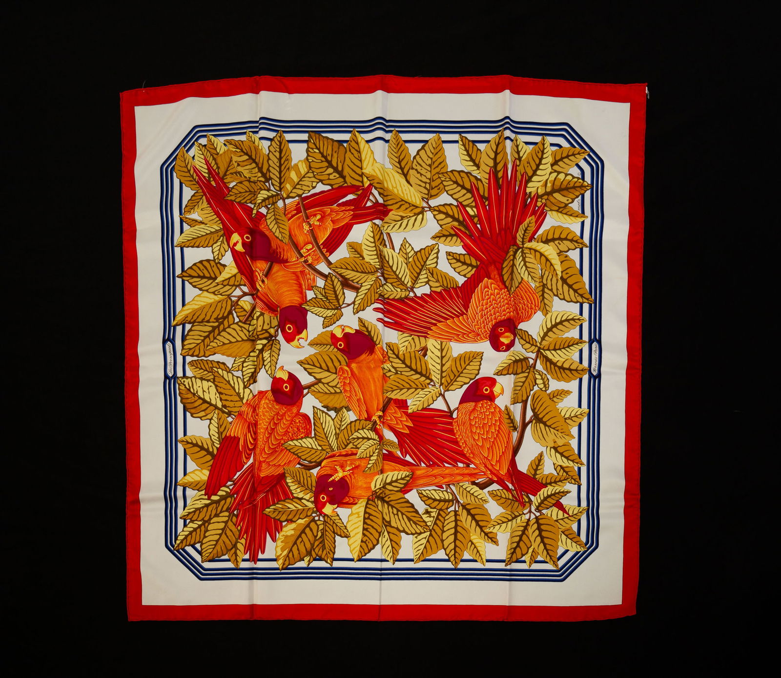 HERMES SILK 90 SCARF "LES PERROQUETS".: Silk. Red border, ivory ground with blue line border. Orange birds with pink and purple heads. 35" square. In original box. Light staining.