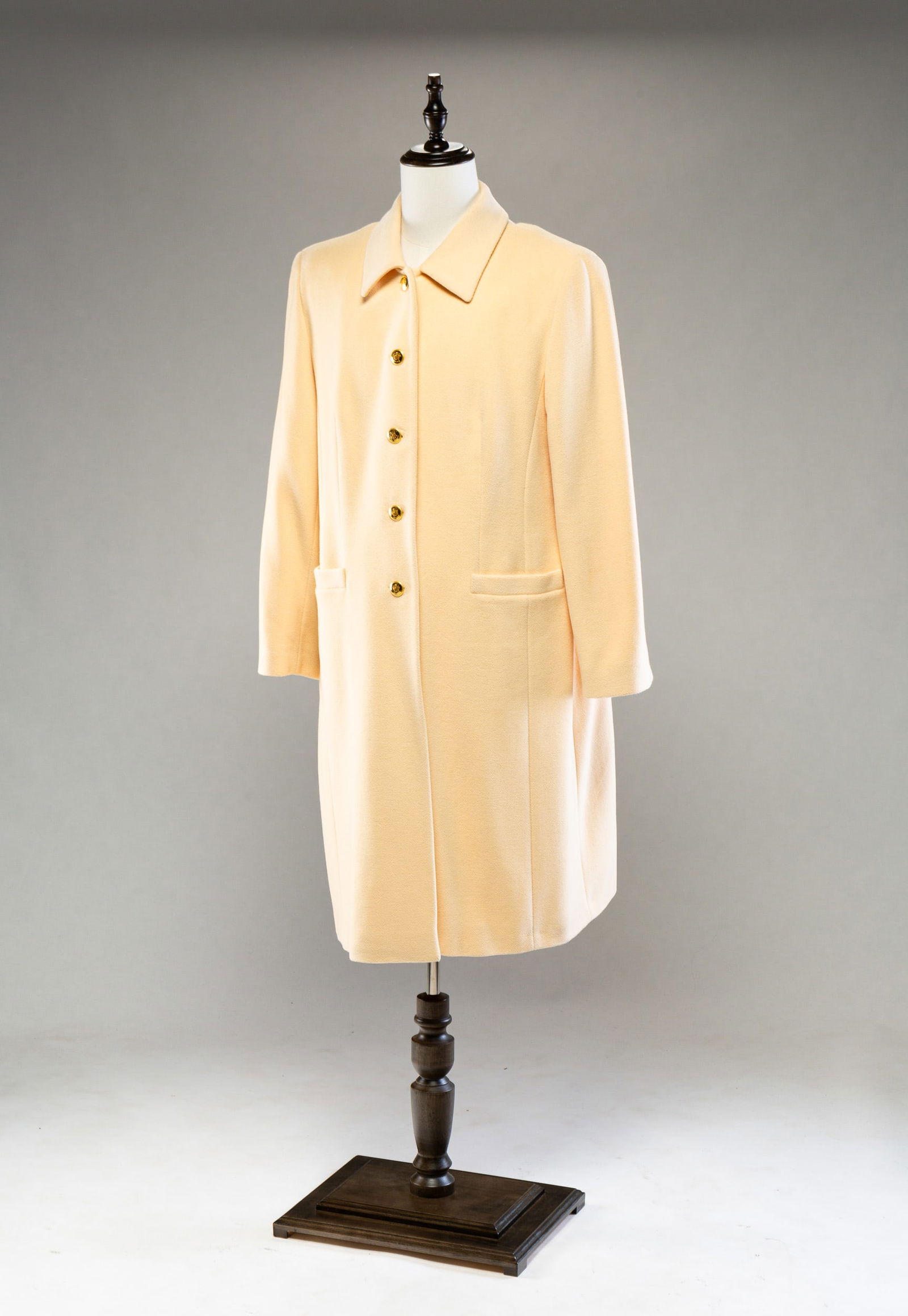 ESCADA CREAM ANGORA WOOL COAT.: French. Size 44. Full length coat with gold buttons and two pockets. Light wear.
