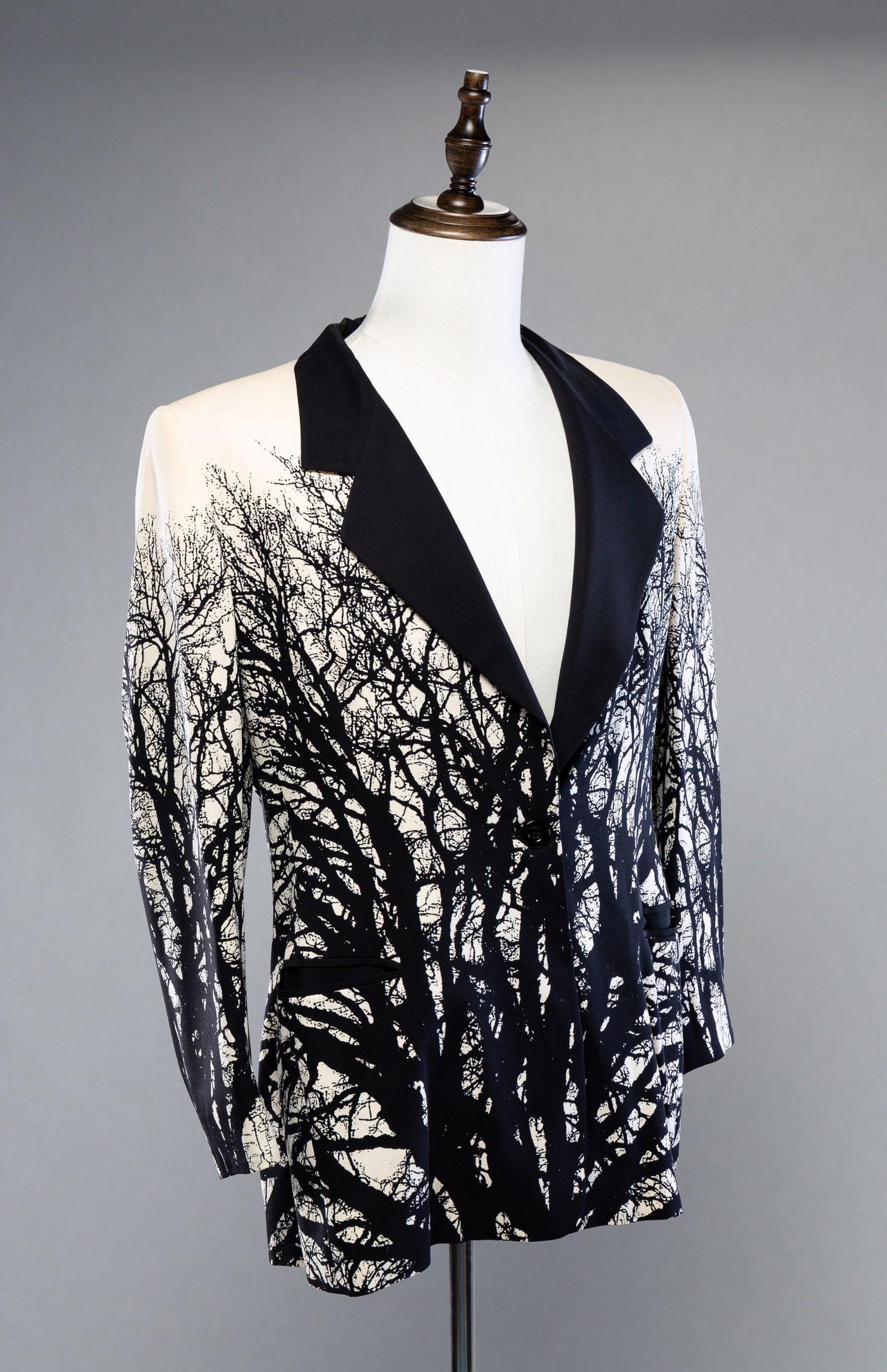 FOUR PIECES OF ESCADA CLOTHING.: German. Silk. Two skirts; black and white pinstripes in size 44, and black skirt with white lines in size 36. Black and white tree motif blazer and silk shirt. Blazer size 42 and shirt size 34. Light