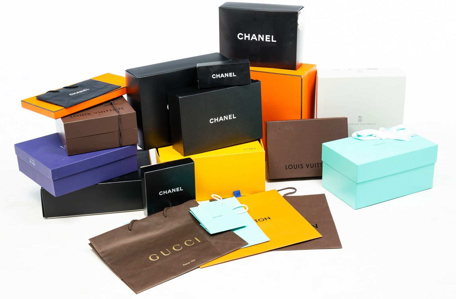 COLLECTION OF DESIGNER CLOTHING BOXES AND BAGS.: Contemporary. Over thirty boxes and bags from Fendi, Louis Vuitton, Chanel, Hermes, Cartier, Tiffany and Co and Stuart Weitzman. Light wear.