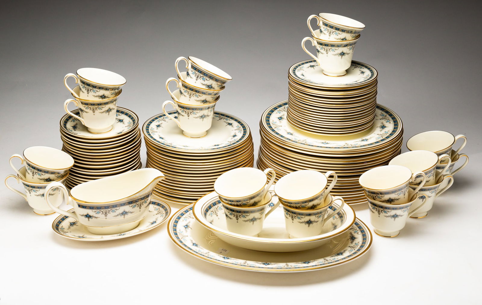 SET OF MINTON "GRASMERE" PATTERN CHINA.: England, patented 1973. Bone China. Nineteen cups, nineteen saucers, nineteen salad plates, twenty bread and butter plates, twenty dinner plates and four serving pieces.