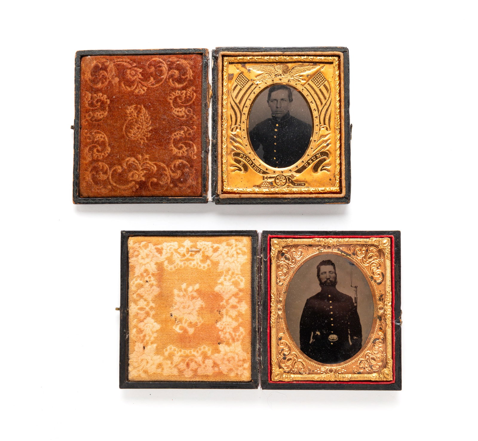 TWO SIXTH PLATE CASED CIVIL WAR IMAGES.: American, third quarter 19th Century. Tintype. Standing uniformed solider holding a rifle with bayonet. Hand colored highlights. And a seated, uniformed man with a patriotic liner. In pressed cardboar