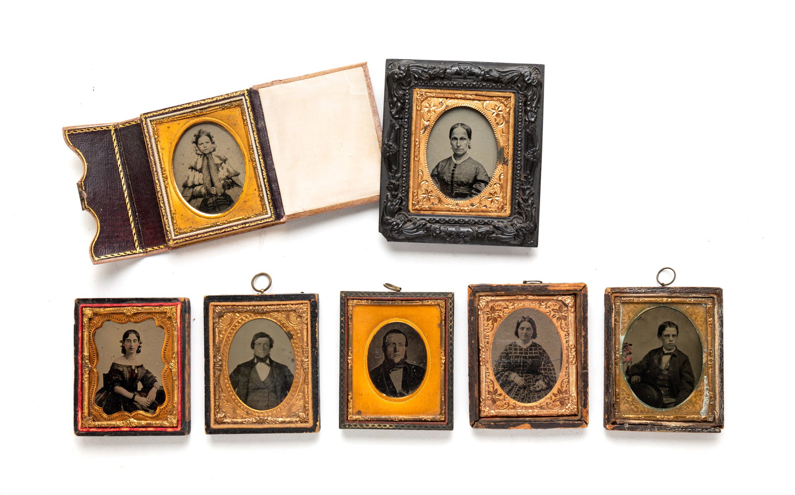 SEVEN NINTH PLATE PORTRAIT IMAGES.: SEVEN NINTH PLATE PORTRAIT IMAGES. American, third quarter 19th Century. Ambrotypes. Few with hand-colored highlights. Featuring two of seated gentlemen, one of a young girl and three of women. One in