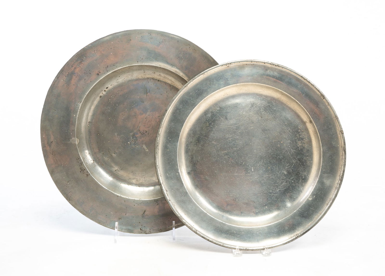 TWO PEWTER CHARGERS.: TWO PEWTER CHARGERS. England, circa 1800. Pewter. Unmarked. 16.75" dia. And Burford and Green. 14.75" dia.