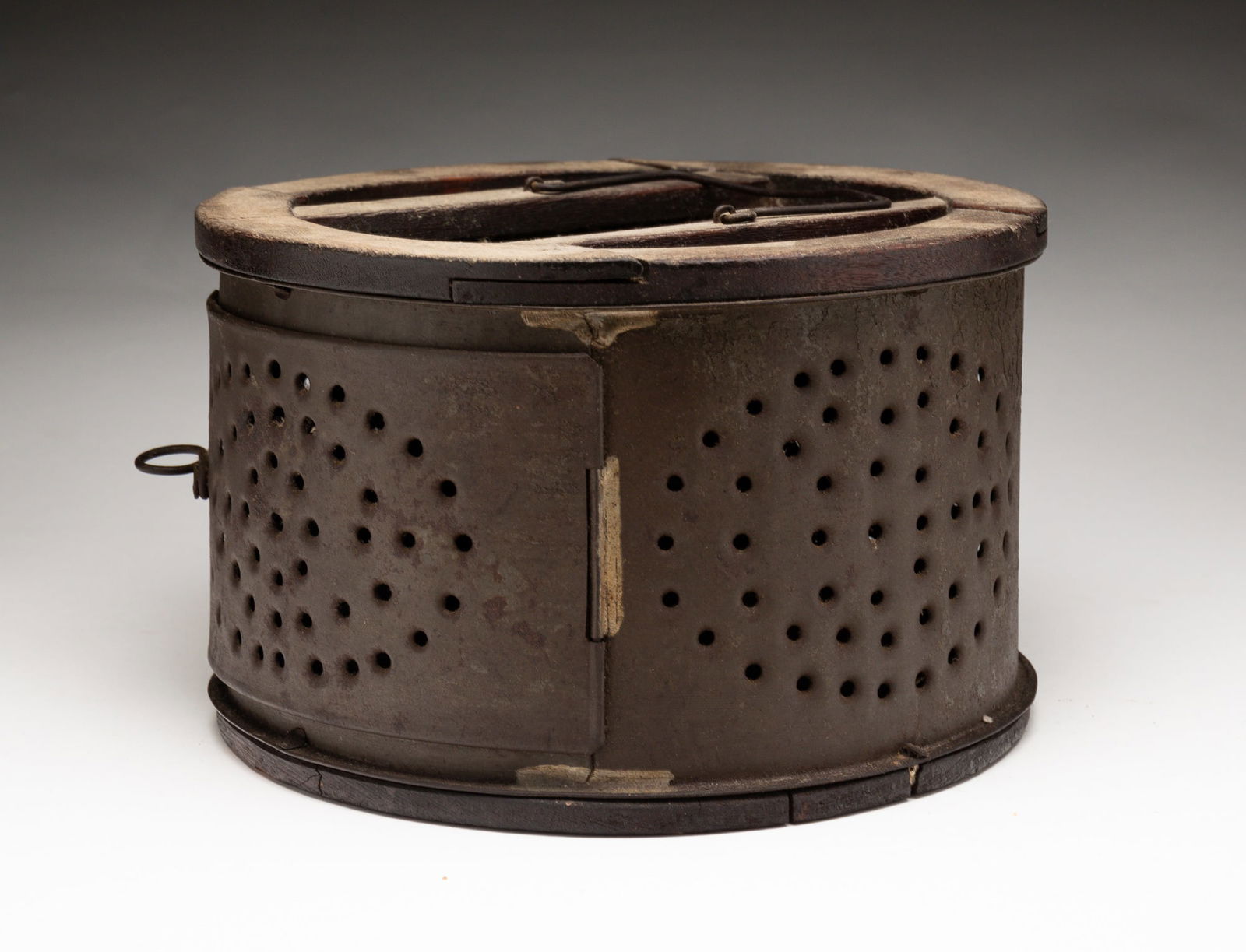 ROUND PUNCHED TIN FOOT WARMER. (1 of 3)