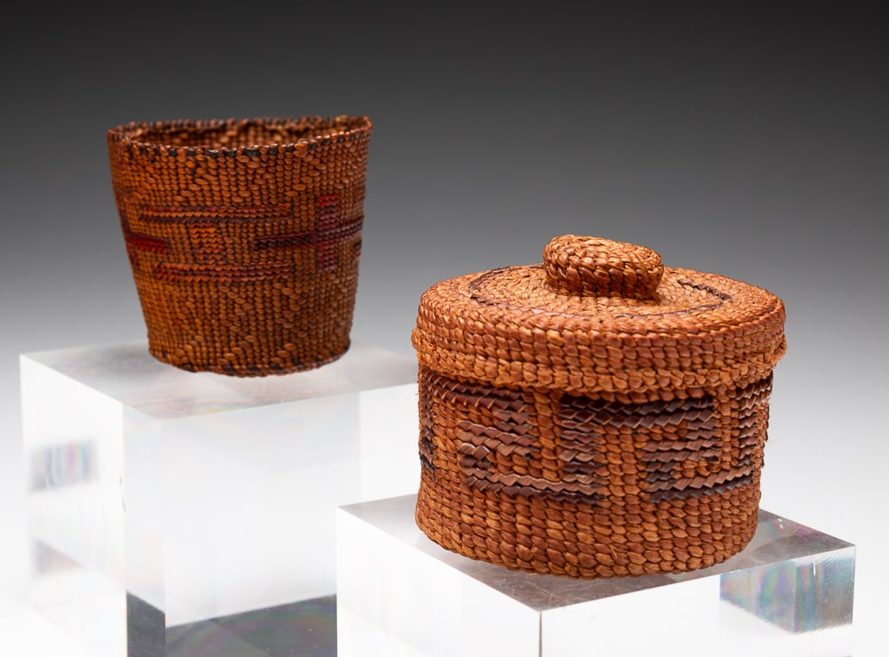 TWO SMALL NORTHWEST TSIMSHIAN BASKETS.: Circa 1900. Small lidded and open basket decorated throughout with polychrome cross motifs. Overall good condition. Lidded basket 2.25"h. 2.5"dia. Small basket 2"h. 2.5"dia.We do not guarantee tribal 