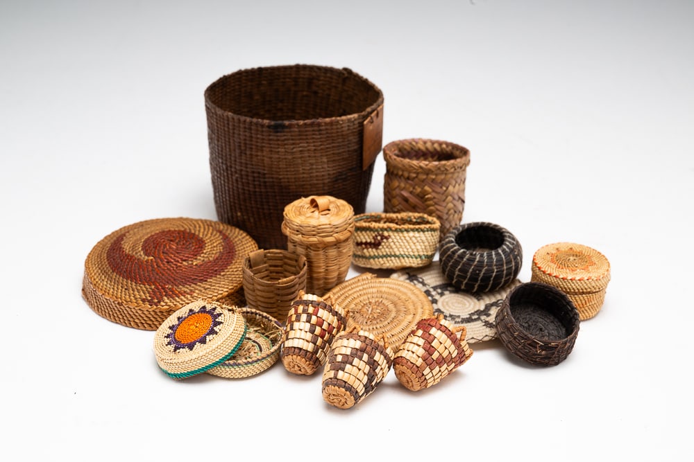 GROUP OF MINIATURE FIRST NATIONS BASKETS.: Early-20th Century. Twelve miniature Makah, Salish. and Tlingit baskets decorated with polychrome designs and figural and animal motifs. Overall good condition. Largest 2"h. 3.5"dia.We do not guarante