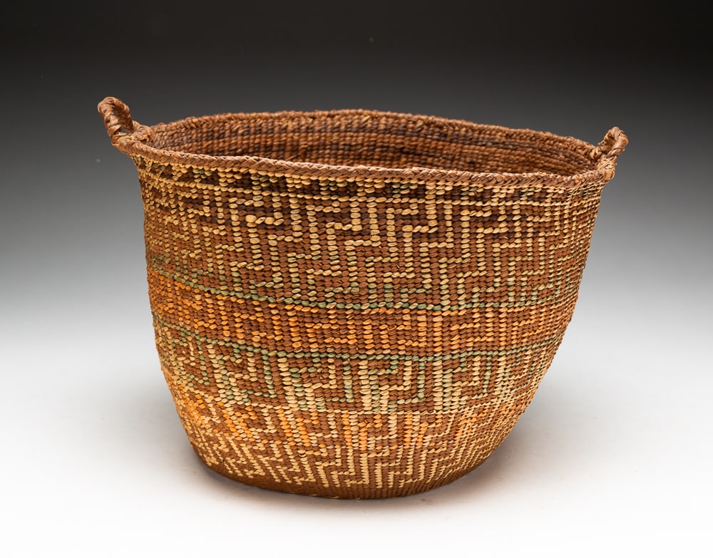 FINE POLYCHROME NORTHWEST COAST BASKET.: Circa 1900. Fine weave with yellow, red, and green graphic pattern with original handles. Overall fine condition. 8"h. 11"w.We do not guarantee tribal attributions for American Indian / First Nations 