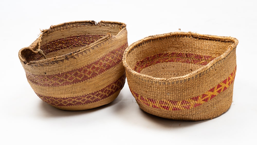 TWO NORTHWEST COAST GATHERING BASKETS.: First half 20th Century. Polychrome banded decoration in maroon and black. With old handle and some edge damage. 8.5"h. Polychrome banded decoration in red and yellow. Overall good condition. 7.5"h. 1