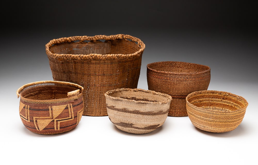 FIVE NORTHWEST COAST BASKETS.: Early-20th Century. Baskets or bowls decorated throughout with banded motifs. Each basket varies from good to "as-is" condition with minor staining, breaks, and damage to rims. Largest 7"h. 8"w. 8"l. 