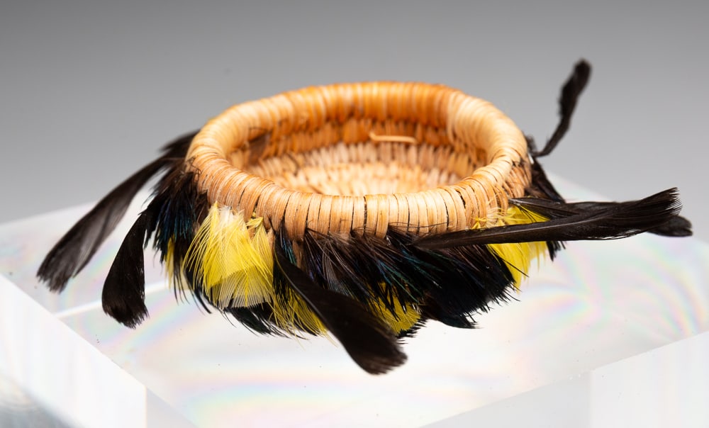POMO MINIATURE FEATHER BASKET.: Pomo, second half 20th Century. Decorated throughout with black, green, and yellow feathers. Excellent condition. 0.75"h. 1.5"dia.We do not guarantee tribal attributions for American Indian / First Na
