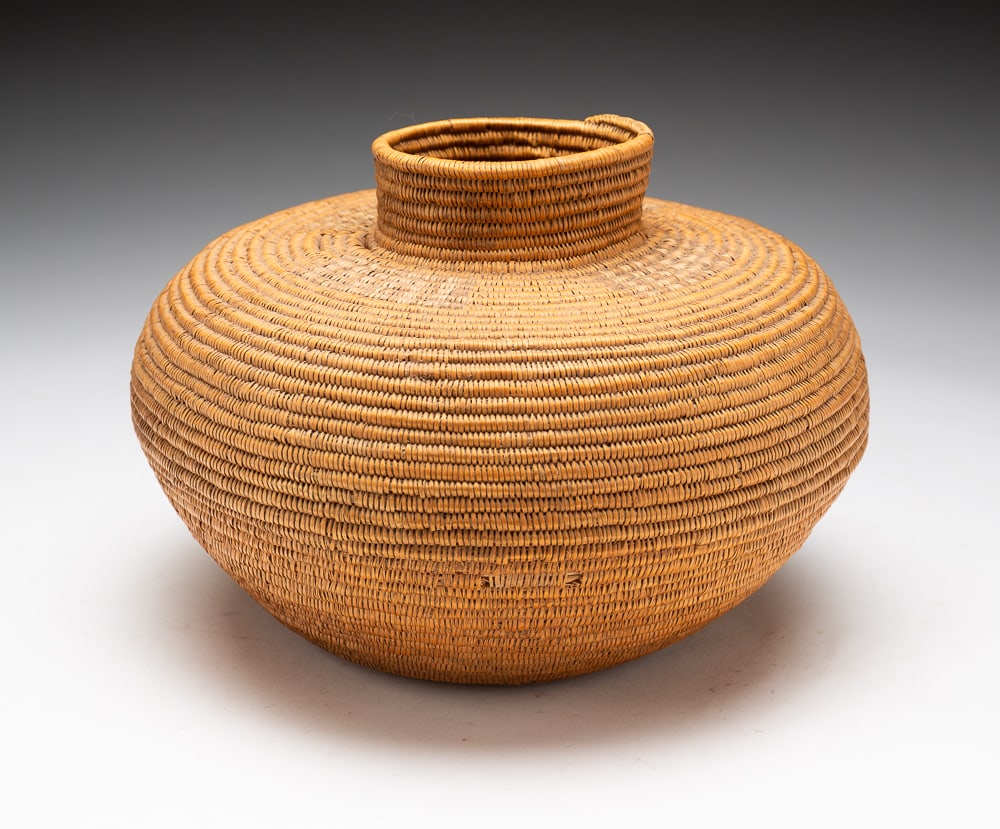 CALIFORNIA BOTTLENECK BASKET.: Circa 1900. Structurally sound bottleneck basket. Overall good condition with some fading. 6.5"h. 8.5"dia.We do not guarantee tribal attributions for American Indian / First Nations items.