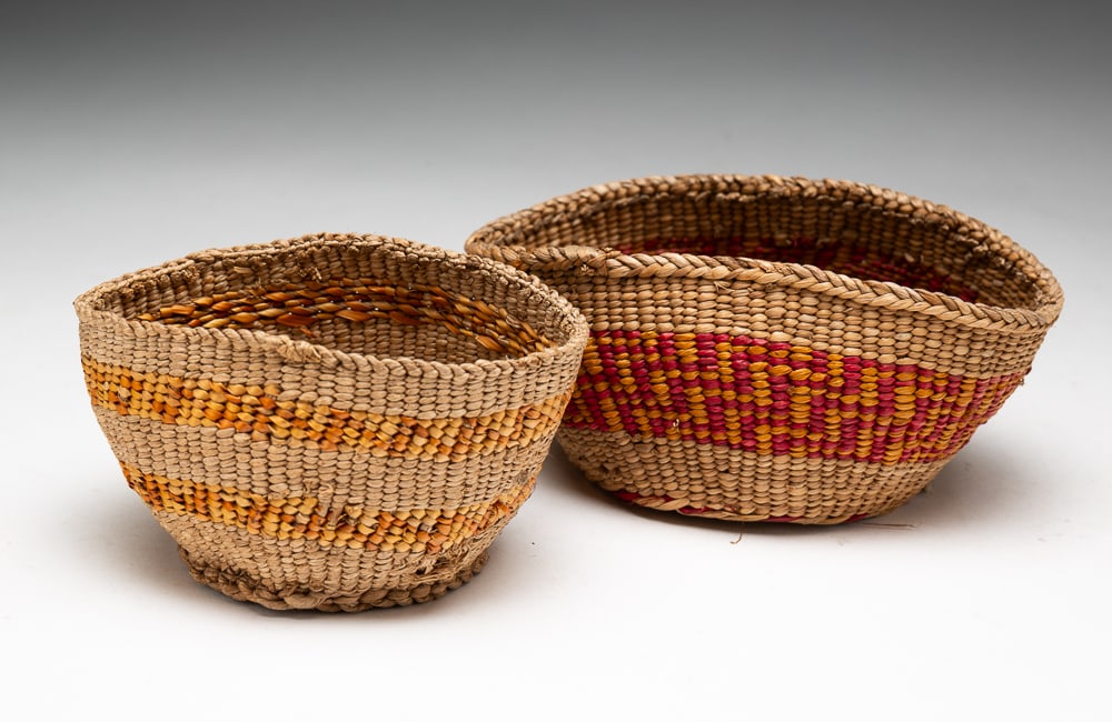 TWO SHASTA CALIFORNIA OKWANUCHU BASKETS.: Okwanuchu, first half 20th Century. Good color, tops are somewhat misshapen. Larger 2.5"h. 6.5"dia. Smaller 2.5"h. 4.5"dia.We do not guarantee tribal attributions for American Indian / First Nations i
