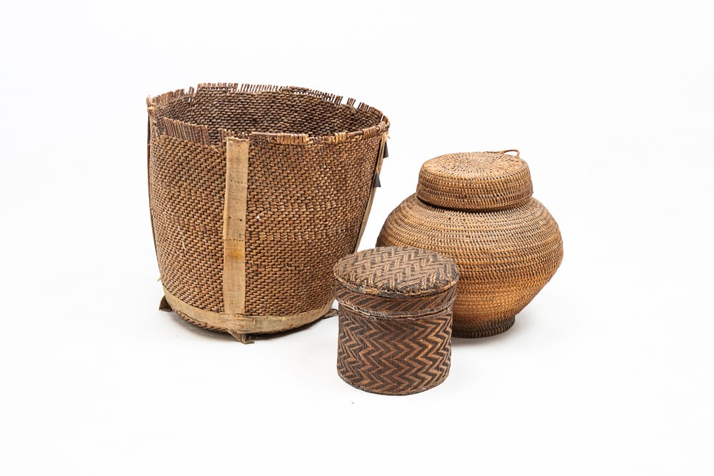 THREE FIRST NATIONS BASKETS.: First Nations, late-19th Century. Possibly Apache burden basket with tin cone jangles. Rim damage. 14"h. 15"dia. Olla basket with original lid. Overall good condition. 10"h. 11"dia. Finely woven lidde