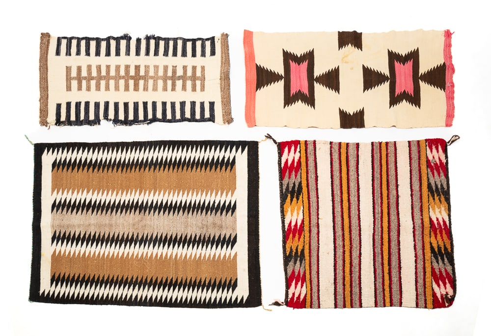 FOUR SMALL NAVAJO RUGS.: Navajo, first half 20th Century. Overall good condition with minor wear throughout. Saddle blanket 30"h. 29"w. Railroad track naturals 34"h. 17"w. Donato 38"h. 19"w. Naturals 40"h. 30w.We do not guara