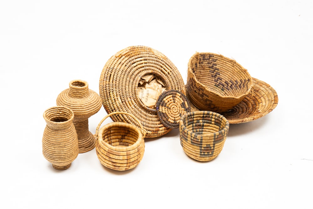 SEVEN ASSORTED FIRST NATIONS BASKETS.: First Nations, 20th Century. Largest has lidded top. Overall good condition. Largest 7"h. 11"dia.We do not guarantee tribal attributions for American Indian / First Nations items.