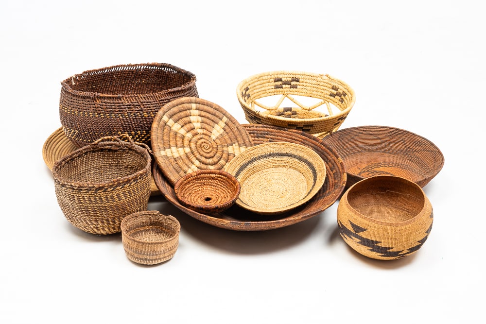 ELEVEN ASSORTED FIRST NATIONS BASKETS.: First Nations, 19th or 20th Century. Southwest and Northwest. Many with damage. 3.5"h. 15"dia.We do not guarantee tribal attributions for American Indian / First Nations items.