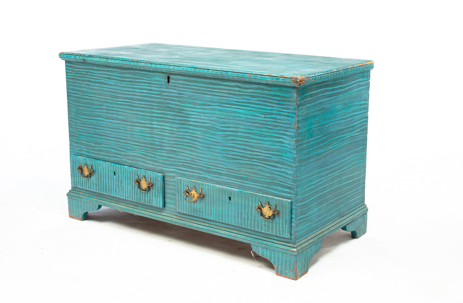 PAINT-DECORATED CHIPPENDALE BLANKET CHEST.: American, circa 1800. Blue and black grain paint over old red. Lid with applied edge moldings. Dovetailed case, two lower overlapping dovetailed drawers, bracket feet. Wear to paint along edges. 26.5"