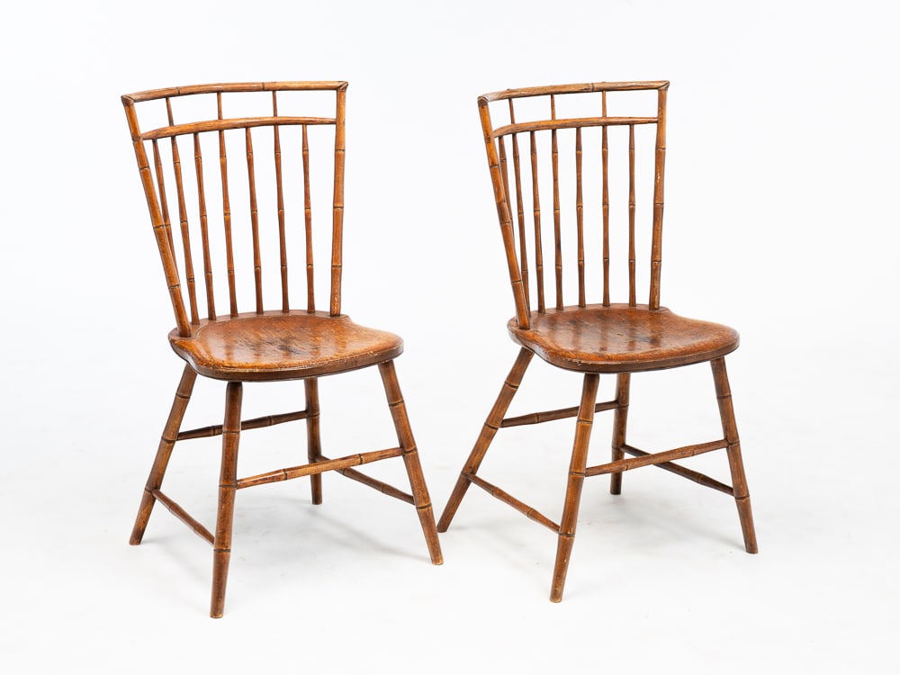 TWO BIRDCAGE WINDSOR CHAIRS.: American, first quarter 19th Century. Bamboo turnings, shaped seats, splayed legs with stretchers. Refinished with wear. Seat 17.5"h. Overall 42"h.