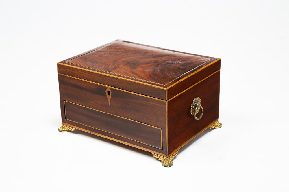 INLAID JEWELRY BOX.: English, first half 19th Century. Mahogany with oak secondary. Line inlays, ring handles, paw feet, lidded fitted compartment and lower dovetailed drawer with spring release. 6"h. 10.5"w. 7.5"d.