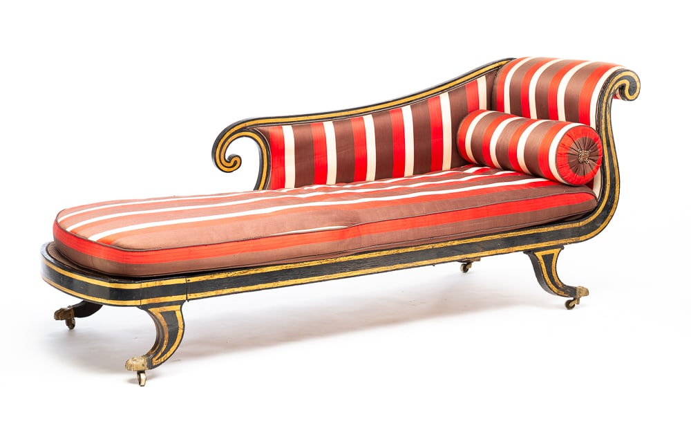 REGENCY RECAMIER.: European, first half 19th Century. Mixed woods. Lyre back, scrolled armrest, saber legs with brass hair paw cup casters. Original black paint with gold striping. Modern striped and corded upholstery.