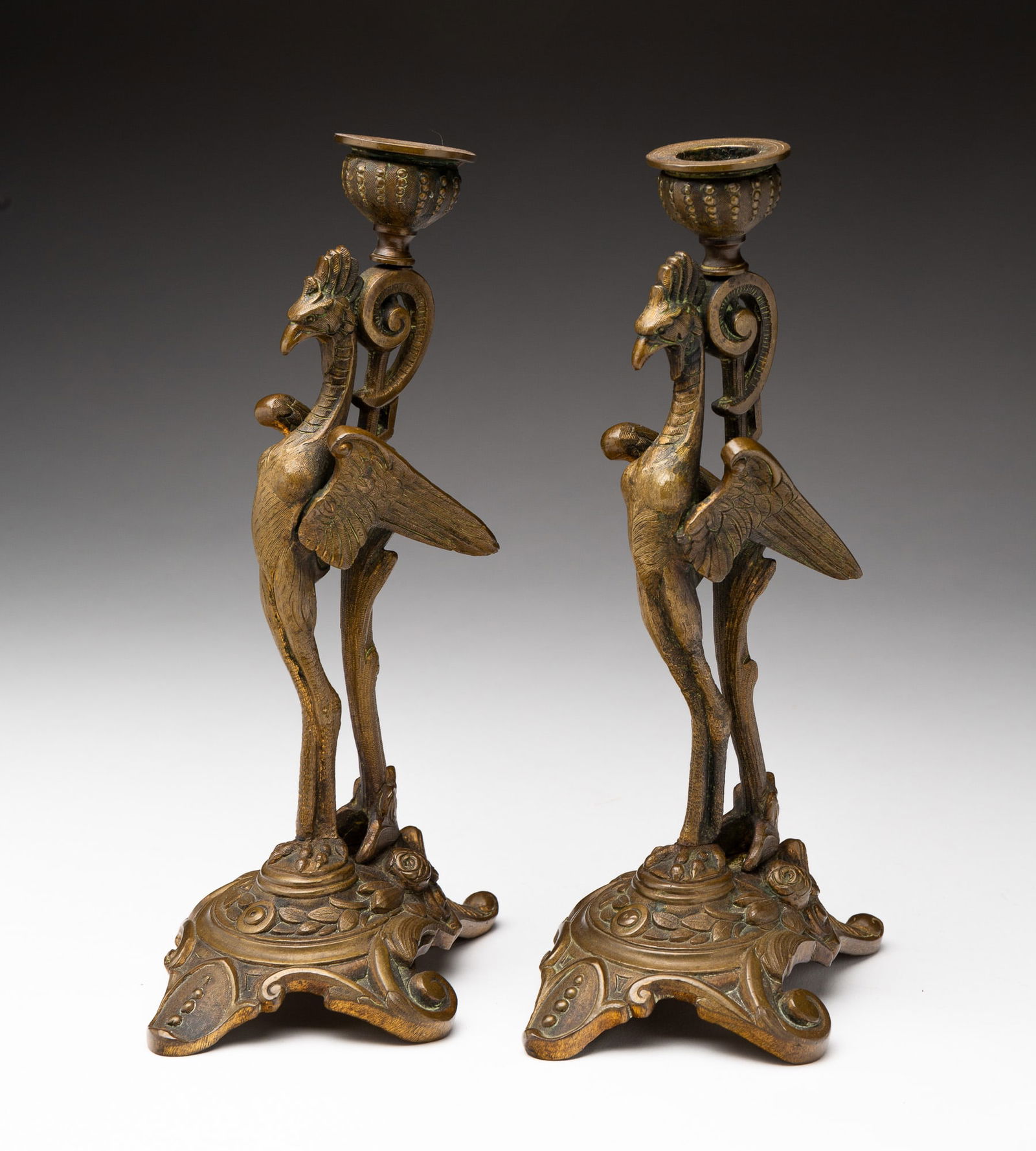 PAIR OF FIGURAL BRONZE CANDLESTICKS.: French, 19th Century. Winged mythological figures with ornate bases. 10"h.
