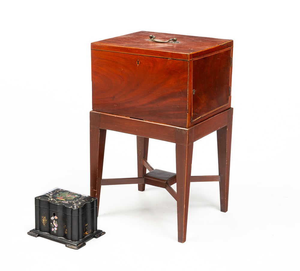 TEA CADDY AND BOX ON STAND.: English, mid-19th Century. Mahogany inlaid box on stand. Locking door opens to two fitted drawers. On stand with "X" stretcher and tapered legs. Wear, repairs, inlay loss. 21"h. 10.5"w. 12.25"d. And a