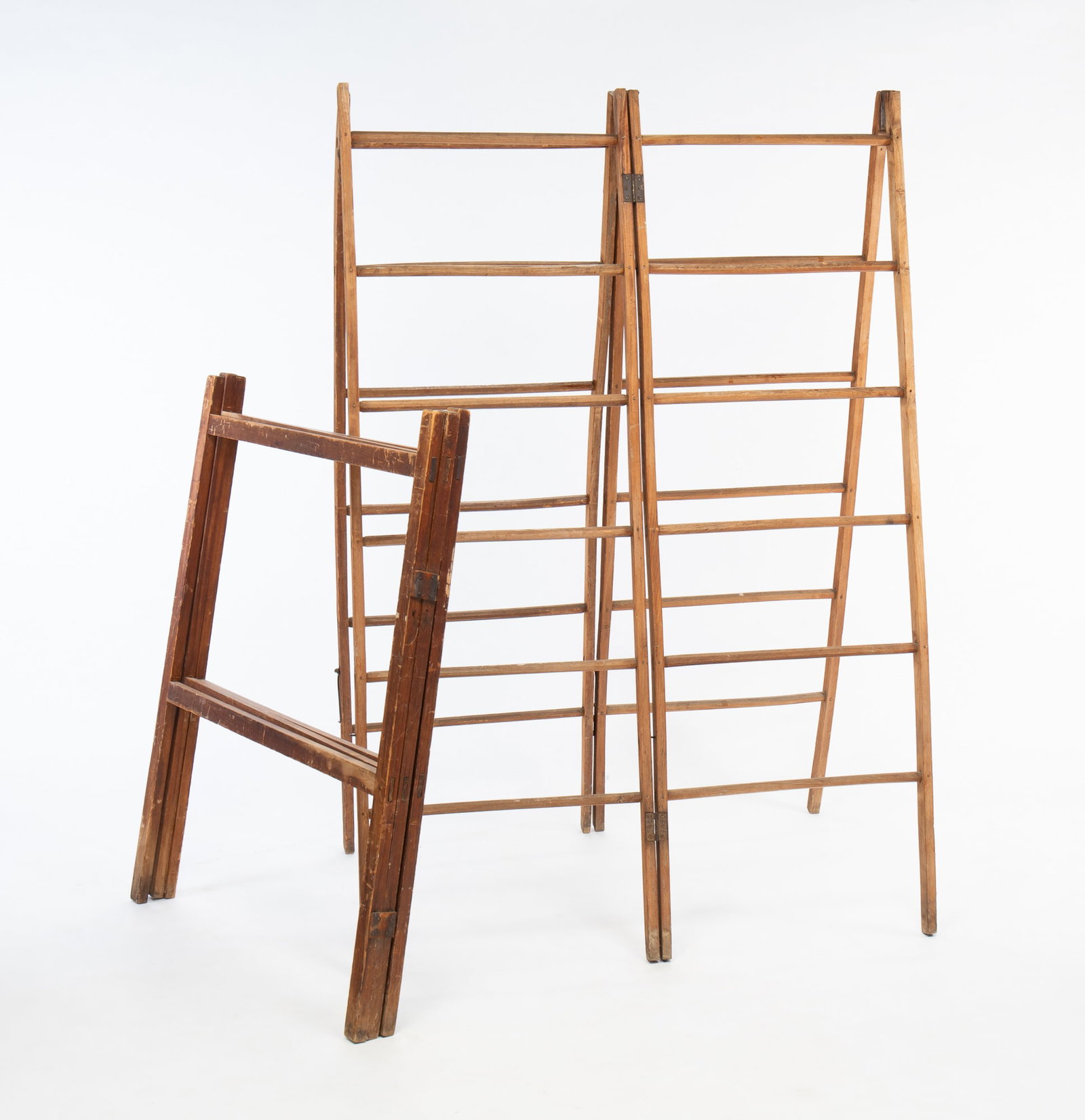 TWO QUILT RACKS.: American, late 19th Century. Taller is oak and maple with hexagonal rungs and four sections. 69.5"h. 23.25"w. Per section. And the shorter is pine with mortised construction and leather hinges. 45.5"h