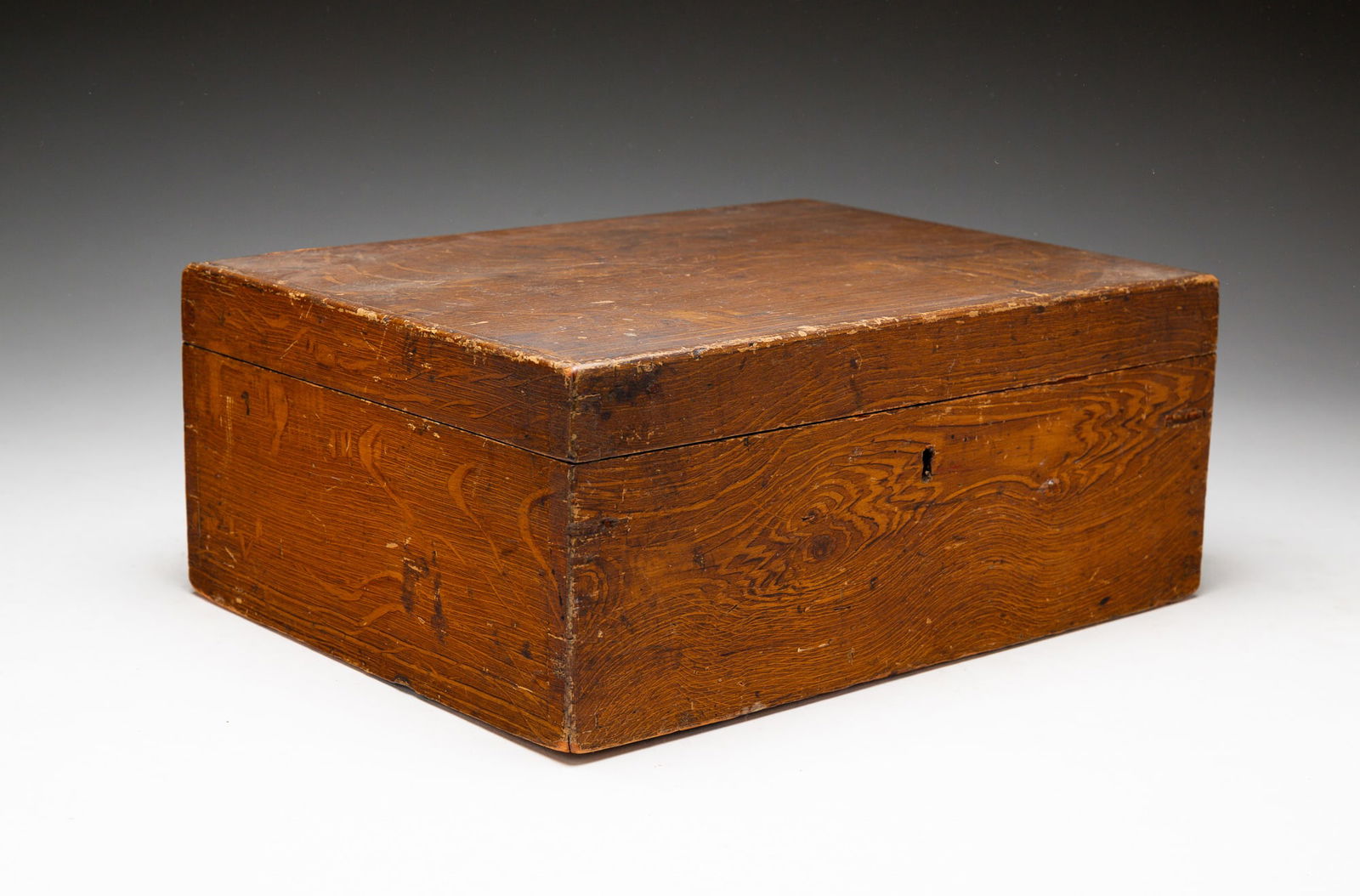 GRAIN-PAINTED DOCUMENT BOX.: American, mid-19th Century. Dovetail construction, hinged lid, interior painted blue. With key. Sliver of wood missing from top left edge of back. 5"h. 12"w. 9"d.