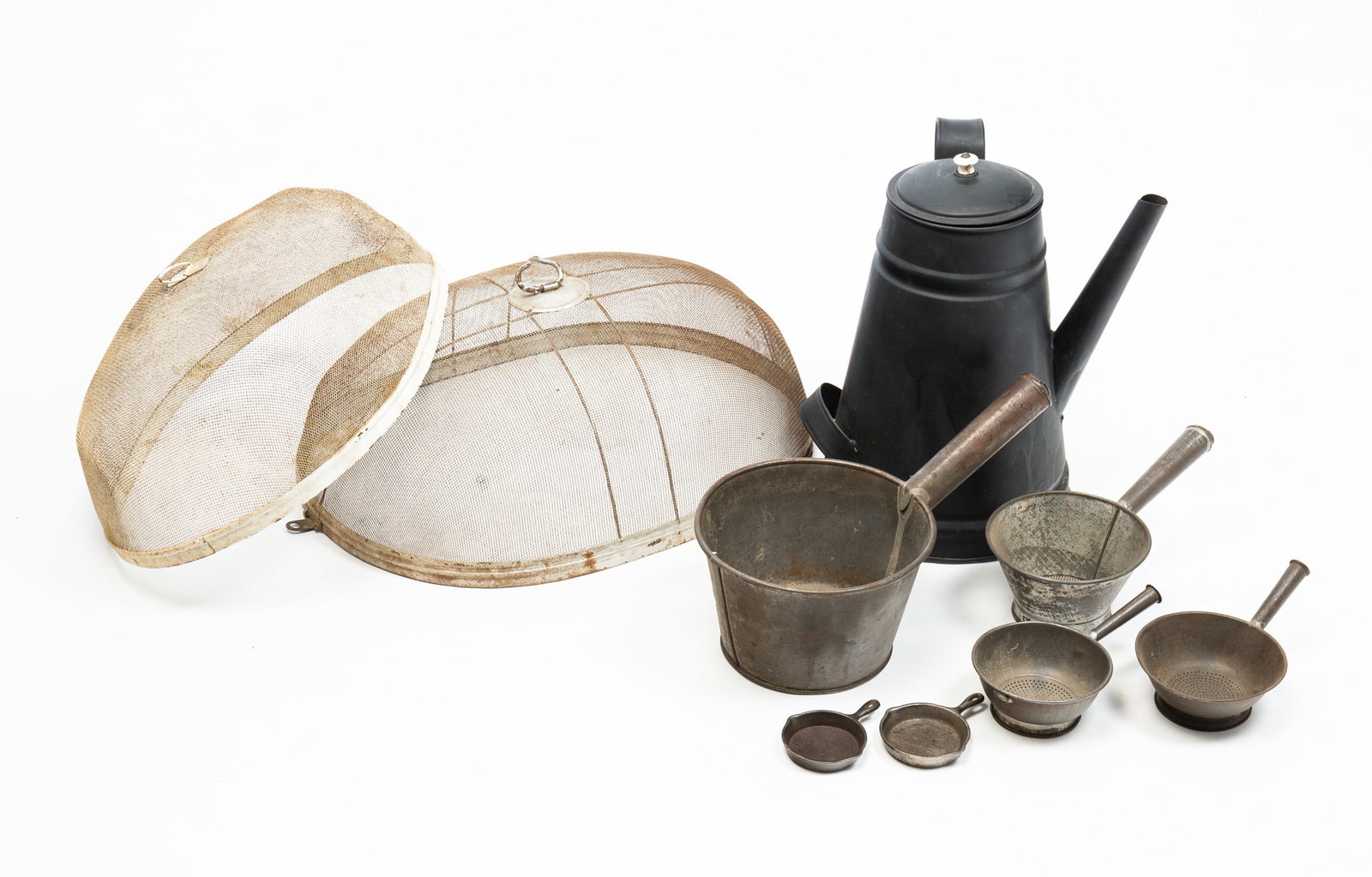 GROUP OF AMERICAN AND ENGLISH METAL KITCHEN WARES.: American and English, 19th and 20th Centuries. Nine pieces total. Comprising a painted black tin coffee pot with white porcelain knob; a tin pot with handle; three tin colanders in graduating sizes; t