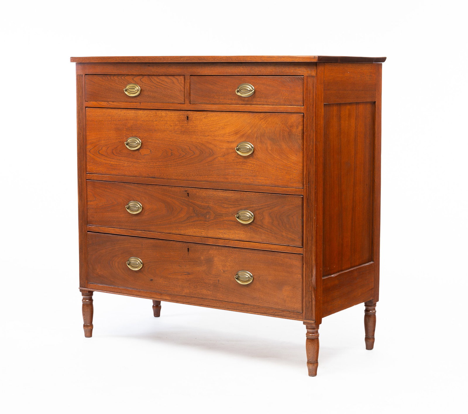 SHERATON CHEST OF DRAWERS.: American, second quarter 19th Century. Walnut with poplar secondary. Paneled ends, two over three dovetailed drawers with beaded edges, reeded stiles and turned legs. Refinished with replaced brasses.