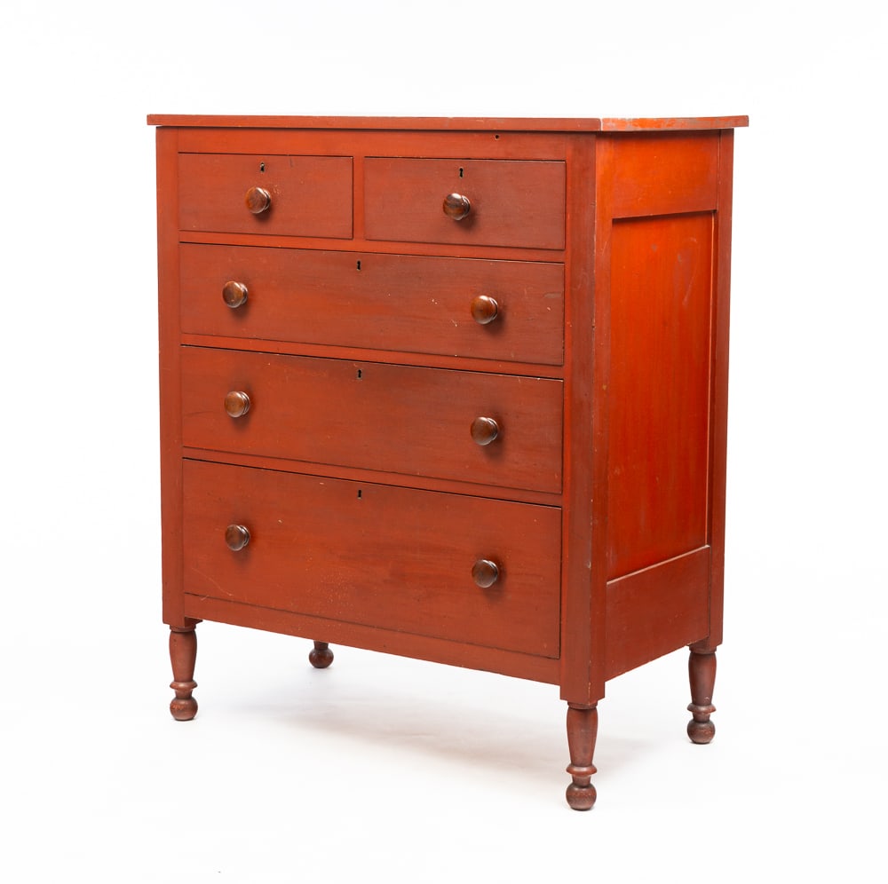 LATE COUNTRY SHERATON CHEST OF DRAWERS.: American, second quarter 19th Century. Cherry with poplar secondary. Paneled ends, two over three dovetailed drawers and turned legs. Original red finish has some wear. Age splits, some edge damage an