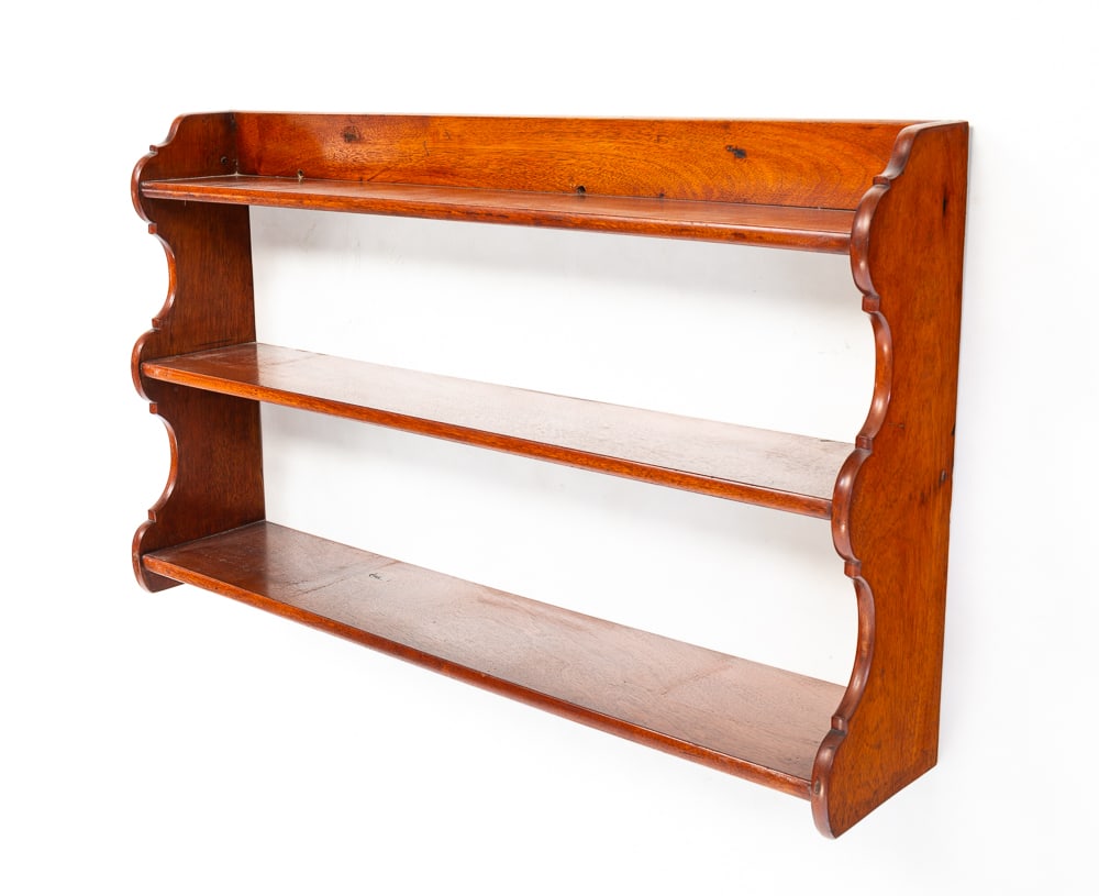 SET OF HANGING SHELVES.: American, mid-20th Century. Mahogany. Shaped ends, three shelves, top of which has a backsplash. Refinished. 21.5"h. 36"w. 7.25"d.