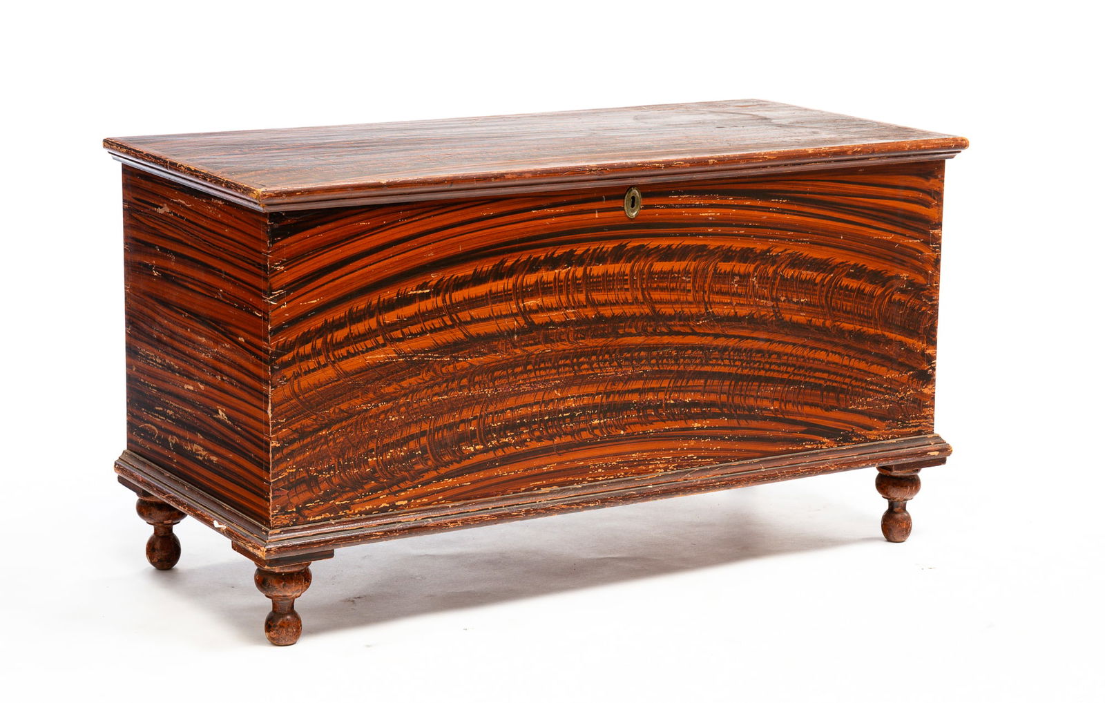 COUNTRY EMPIRE GRAIN-PAINTED BLANKET CHEST.: American (Pennsylvania, Adams County), mid-19th Century. Poplar. Lid with applied edge moldings, dovetailed case, turned legs and interior lidded till. Wear to paint, edge losses, lock receiver missin