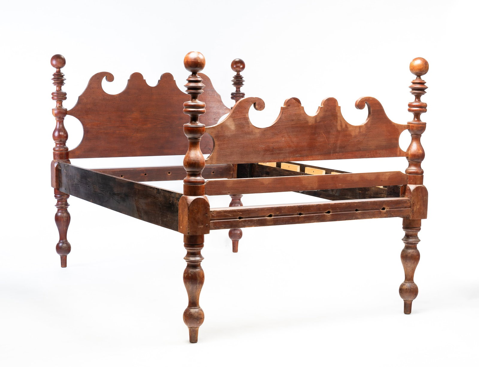 COUNTRY EMPIRE CANNONBALL BED.: American, second quarter 19th Century. Poplar. Heavily turned posts, matching head and foot boards with scrolled lobes and scalloped centers. Refinished with wear. Originally a rope bed and has had ra