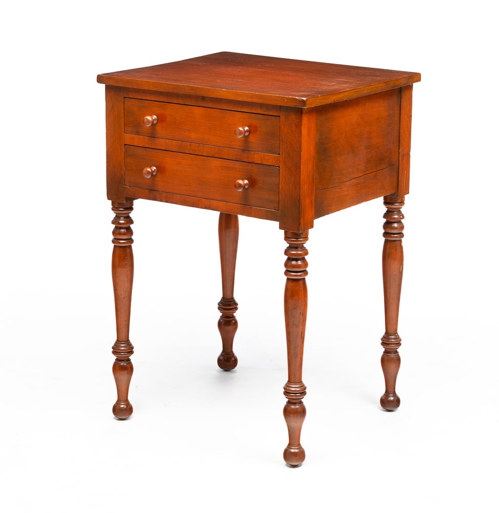 SHERATON TWO DRAWER STAND.: American, second quarter 19th Century. Cherry with pine secondary. Dovetailed drawers and turned legs. Refinished. 29"h. 20"w. 17.5"d.
