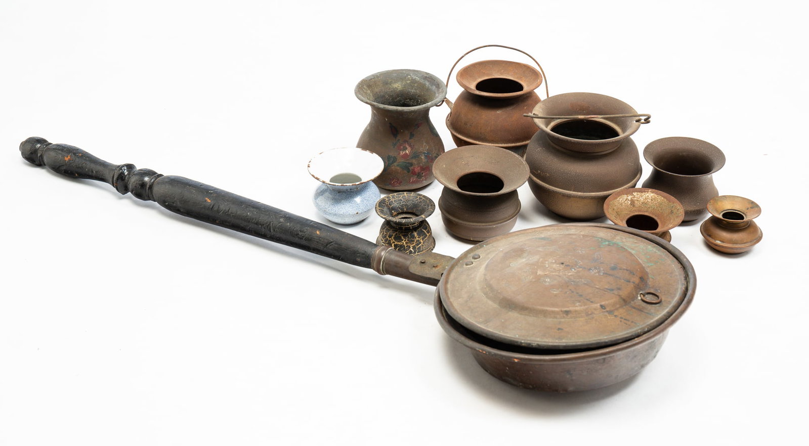 GROUP OF METAL ITEMS.: American, 19th Century. Comprising two spittoons with handles, six cuspidors, a painted toleware vase, and an embossed copper bed warmer. All with extensive wear. Bed warmer 34.5"l. Ten items total.