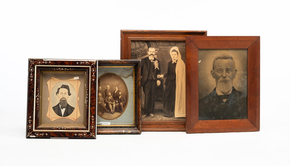 FOUR FRAMED PHOTOGRAPHS.: American, second half 19th Century. A charcoal enhanced wedding portrait. Backed on canvas. Tears. 20.5"h. 17.5"w. A charcoal enhanced portrait of a gray haired man with a goatee. In a beveled walnut 