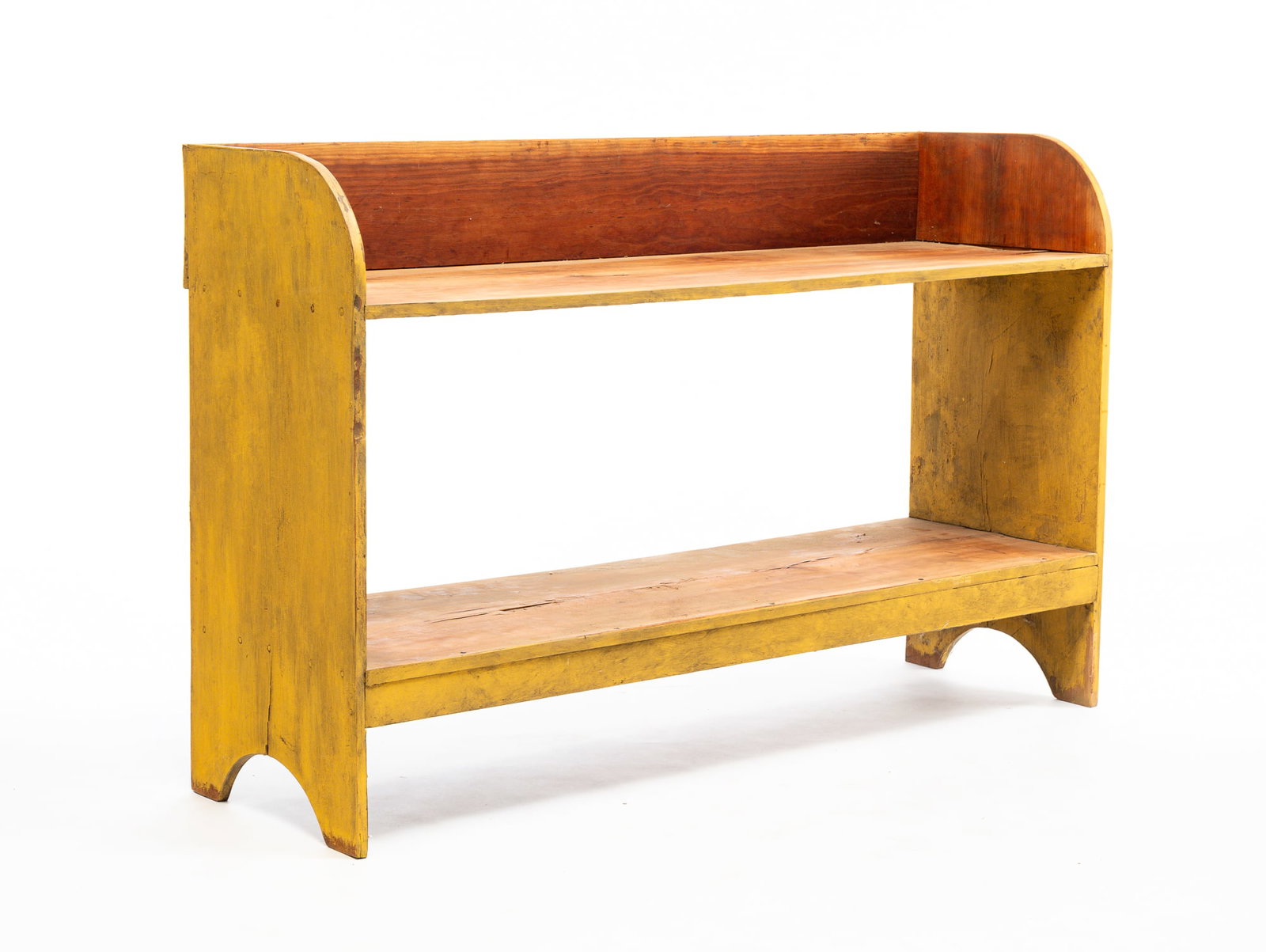 BUCKET BENCH IN YELLOW PAINT.: American, 19th Century. Cherry, gallery back, two shelves, cutout feet. Some wear to paint. 38.75"h. 61"w. 18"d.