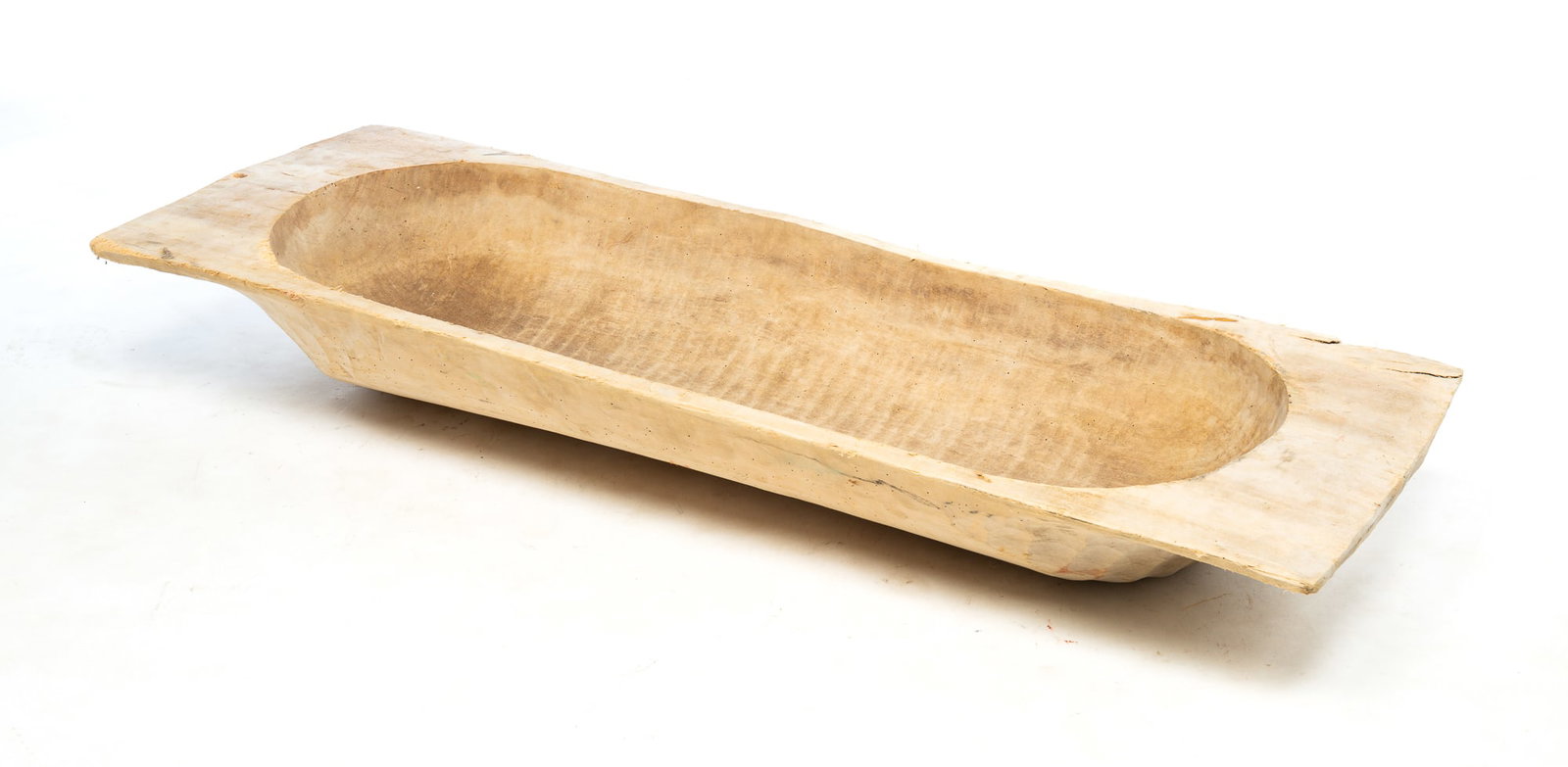 LARGE TRENCHER.: European, 20th Century. Pine. Hand hewn from a single log. Some wear and insect damage. 6.5"h.59"l. 19.5"d.