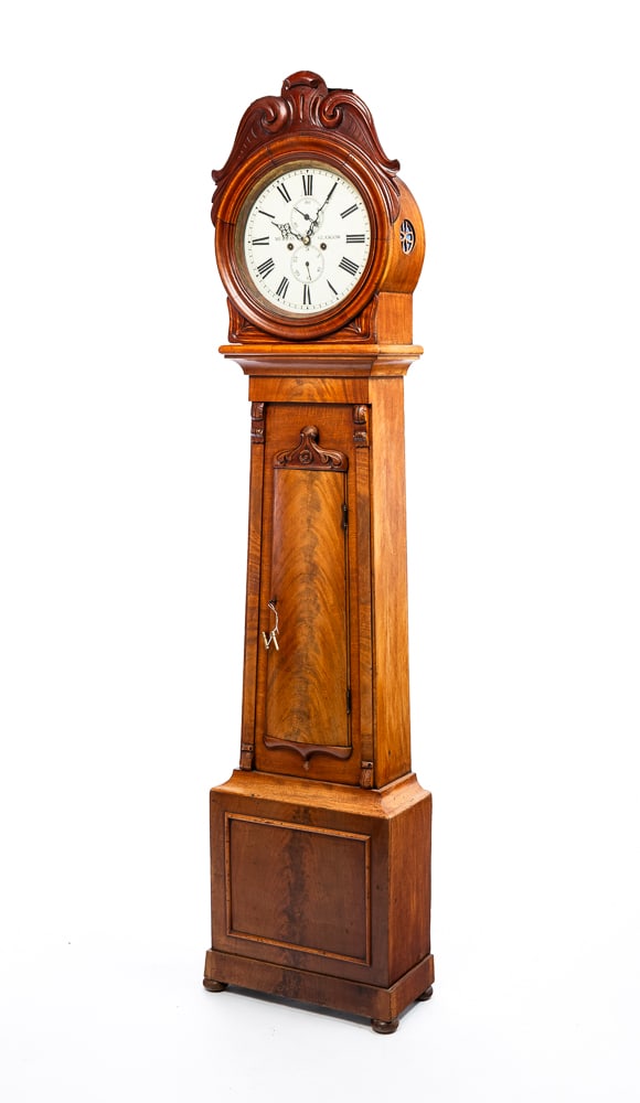 MURRAY TALL CASE CLOCK.: Scottish (Glasgow), mid-19th Century. Mahogany with pine secondary. Round bonnet with carved scrolled crest, case with carted sides, flat pilasters with carved brackets, base with applied moldings and