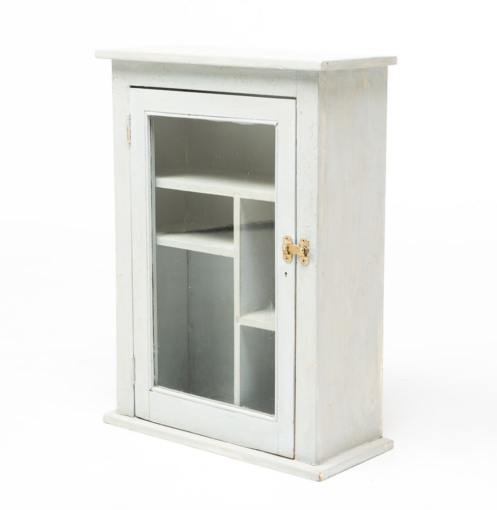 SMALL COUNTER TOP DISPLAY CABINET.: American, circa 1900. Pine. One board top and base, single pane glass door and unusual shell arrangement. Light gray repaint. 23.25"h. 17.25"w.