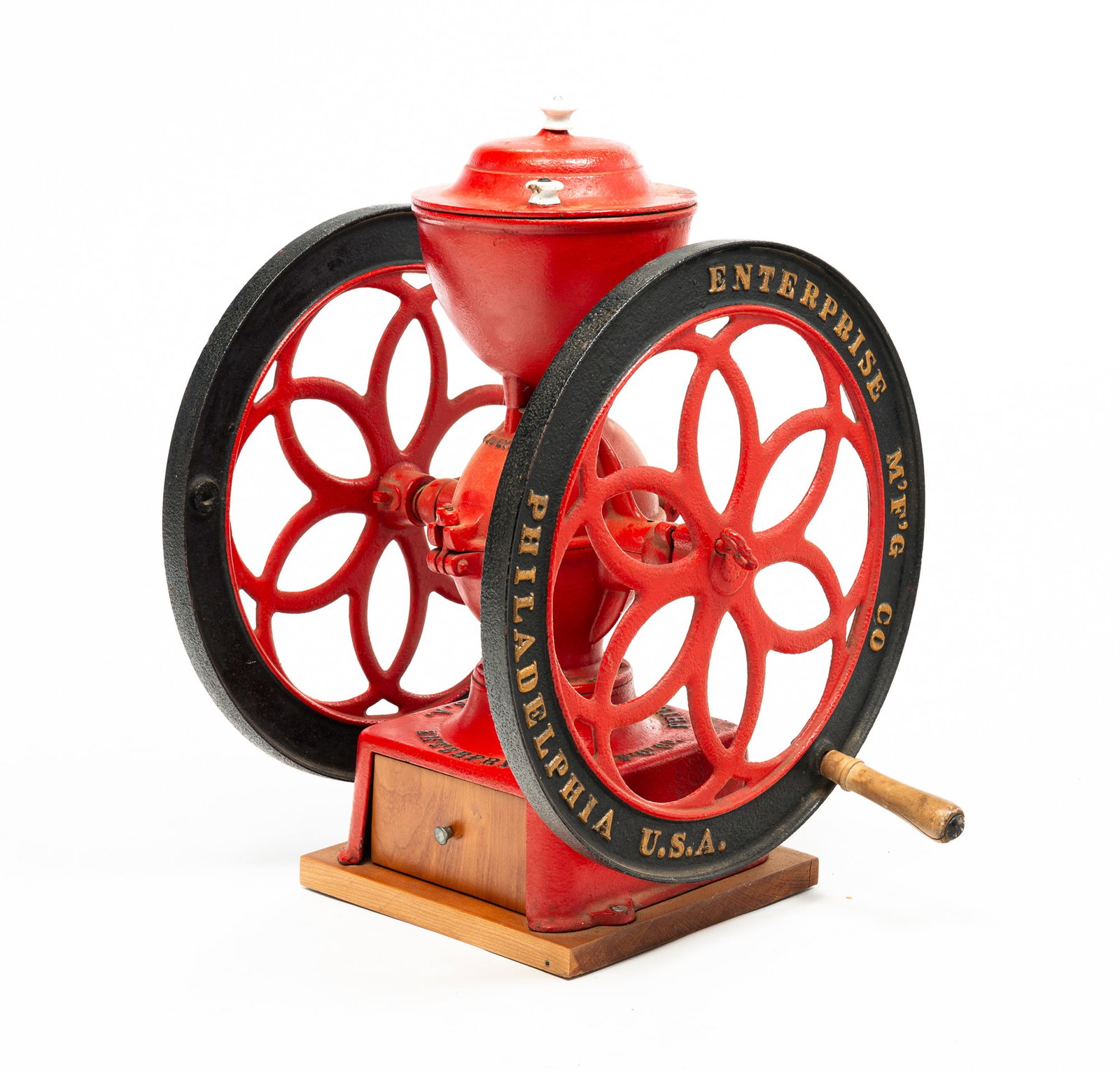 ENTERPRISE COUNTER TOP COFFEE MILL.: American (Philadelphia, Pennsylvania), late-19th Century. Cast Iron. Red, black and gold repaint. Patented July 12, 1898. Replace drawer and base and porcelain lid knob. 22.5"h.