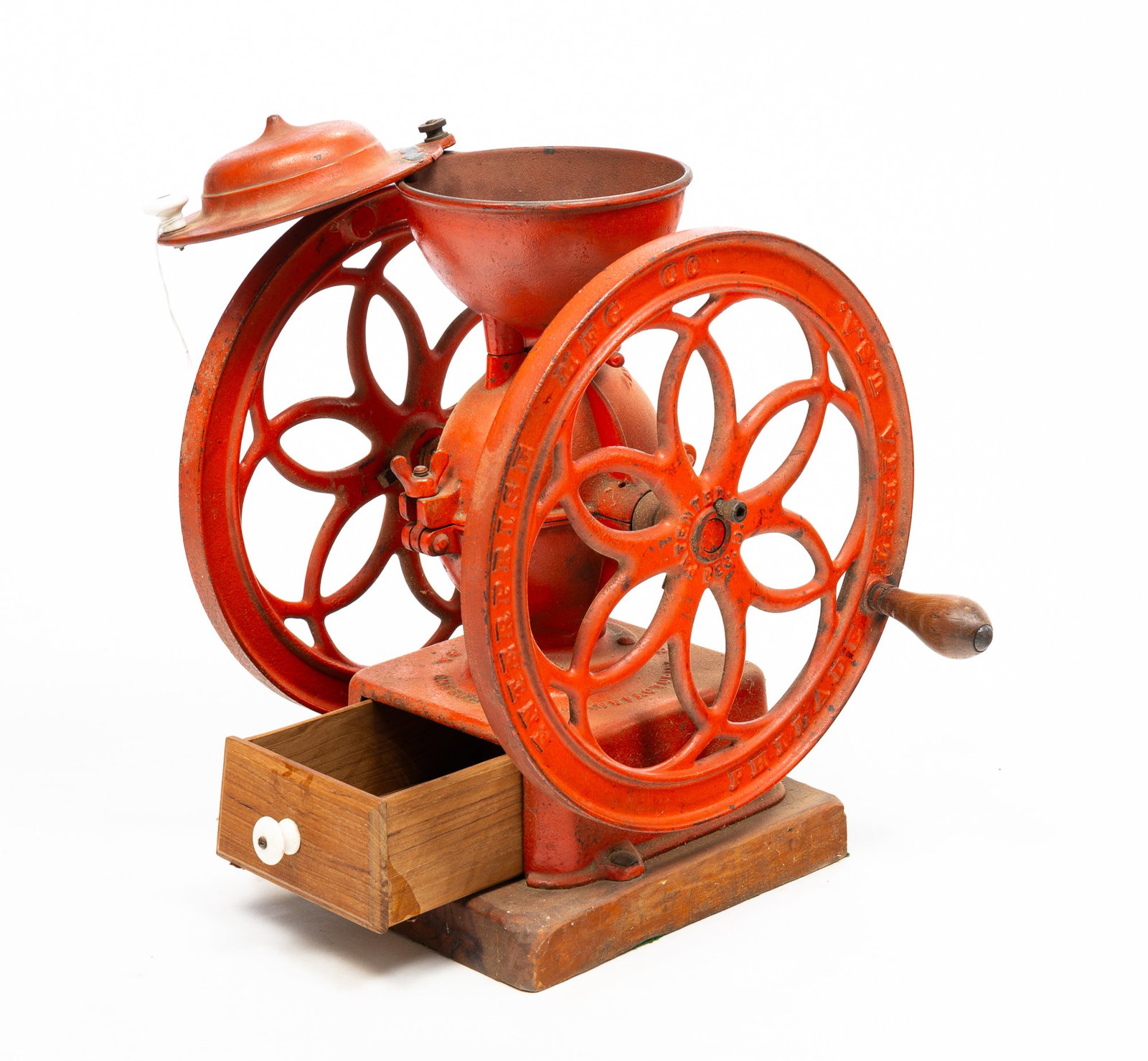 ENTERPRISE COUNTER TOP COFFEE MILL.: America (Philadelphia, Pennsylvania), late-19th Century. Cast Iron. Red repaint, replaced walnut drawer and original walnut base. 17.5"h .