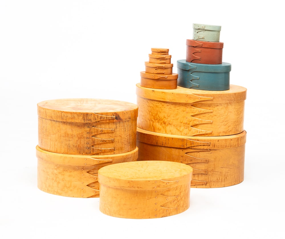 FIVE NESTING SHAKER STYLE PANTRY BOXES.: American, late-20th and early-21st Century. In varied sizes, of oval from constructed with finger joints and copper tacks. Three larger boxes in birdseye maple and two in tiger maple, three smaller bo