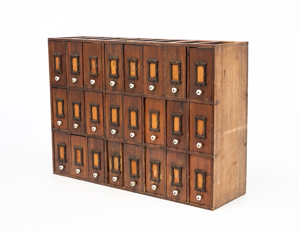 CASE OF DRAWERS.: American, circa 1900. Poplar. Twenty-four bill or receipt drawers with porcelain knobs and label windows. 26"h. 36"w. 10.75"d.