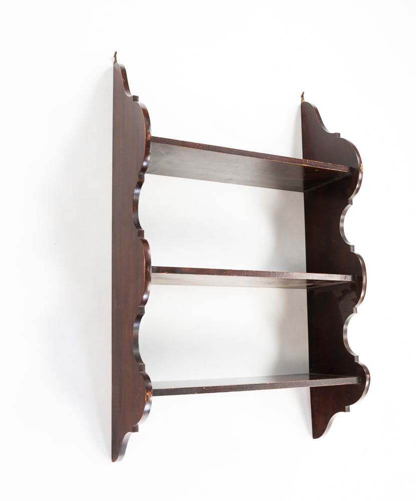 SET OF HANGING SHELVES.: American, late-19th Century. Mahogany. Nicely scalloped sides with three shelves. Some finish wear. 30"h. 18.25"w. 7.5"d.