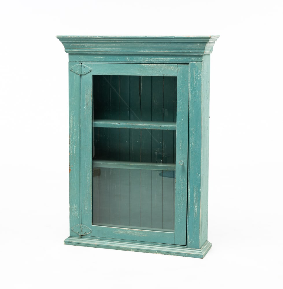 HANGING CABINET.: American, circa 1900. Pine. Molded cornice and base molding, single pane glass door, beadboard back and worn seafoam green paint. 33.5"h. 23.75"w. 6.5"d.