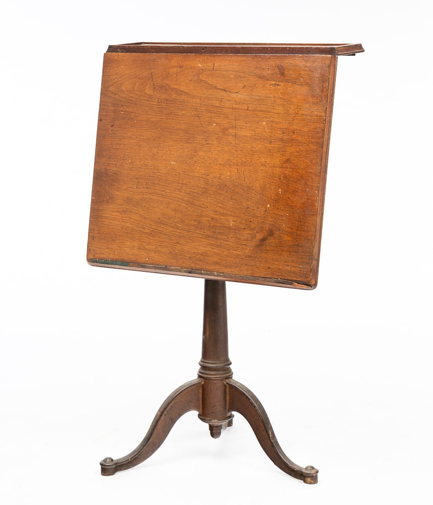 ADJUSTABLE LECTERN.: American, late-19th Century. Hinged walnut top and adjustable cast iron base. Bottom edge of desk missing paper stop. 42.5"h. 26"w.